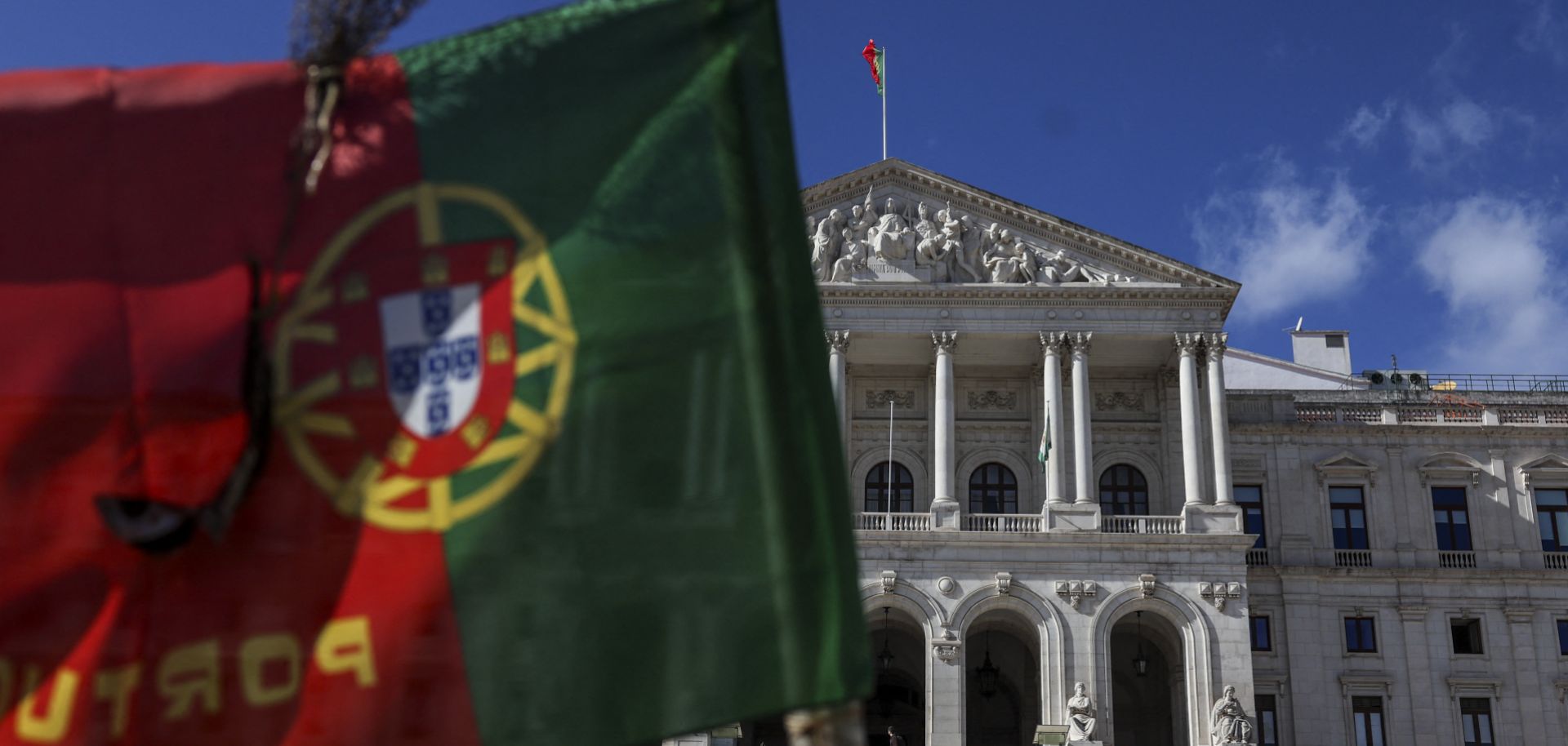 A Portuguese flag flies in front of the parliament in Lisbon on Nov. 7, 2023, after Prime Minister Antonio Costa announced he would resign as head of state in the wake of a corruption scandal involving energy contracts.