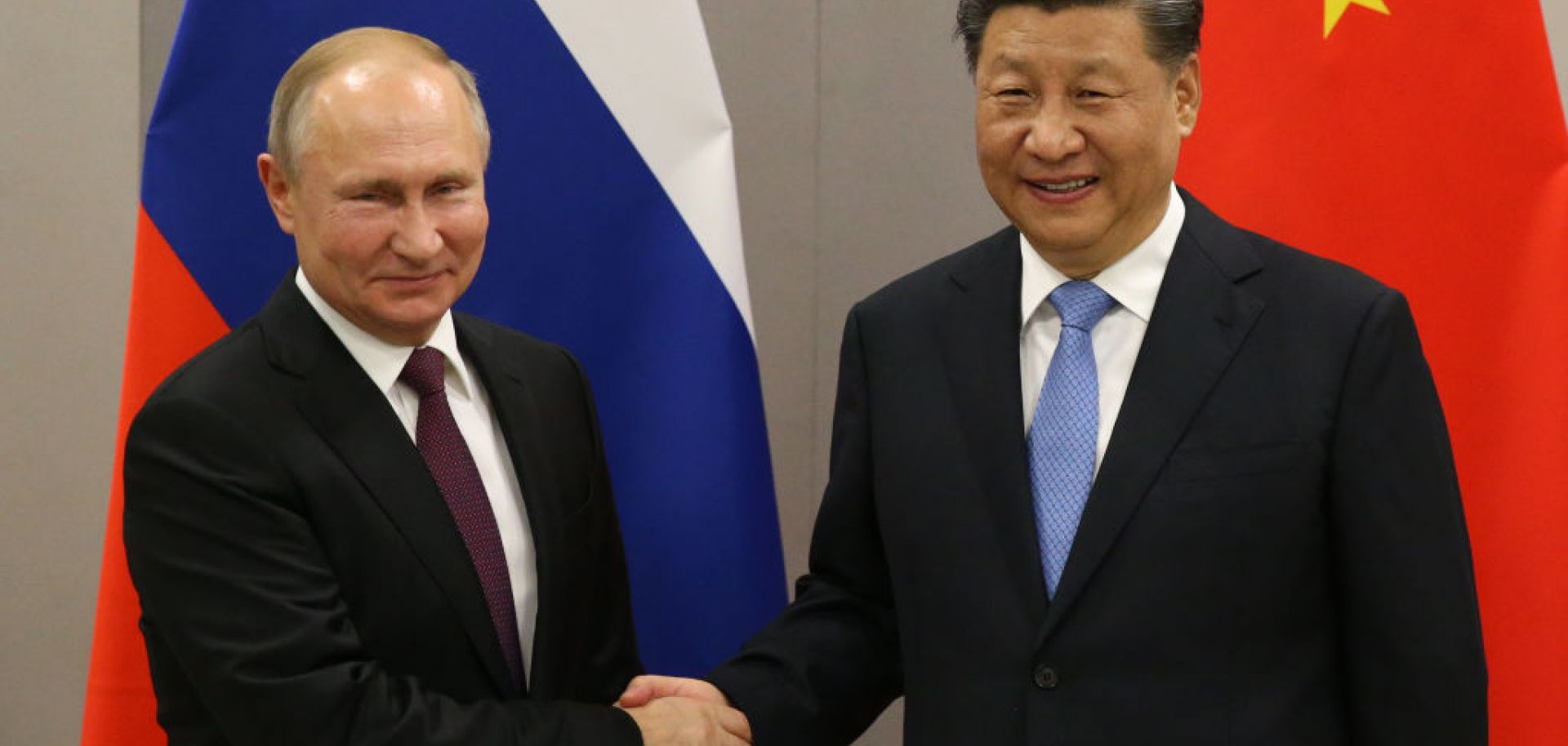 Russian President Vladimir Putin (L) greets Chinese President Xi Jinping in November 2019 in Brasilia, Brazil.