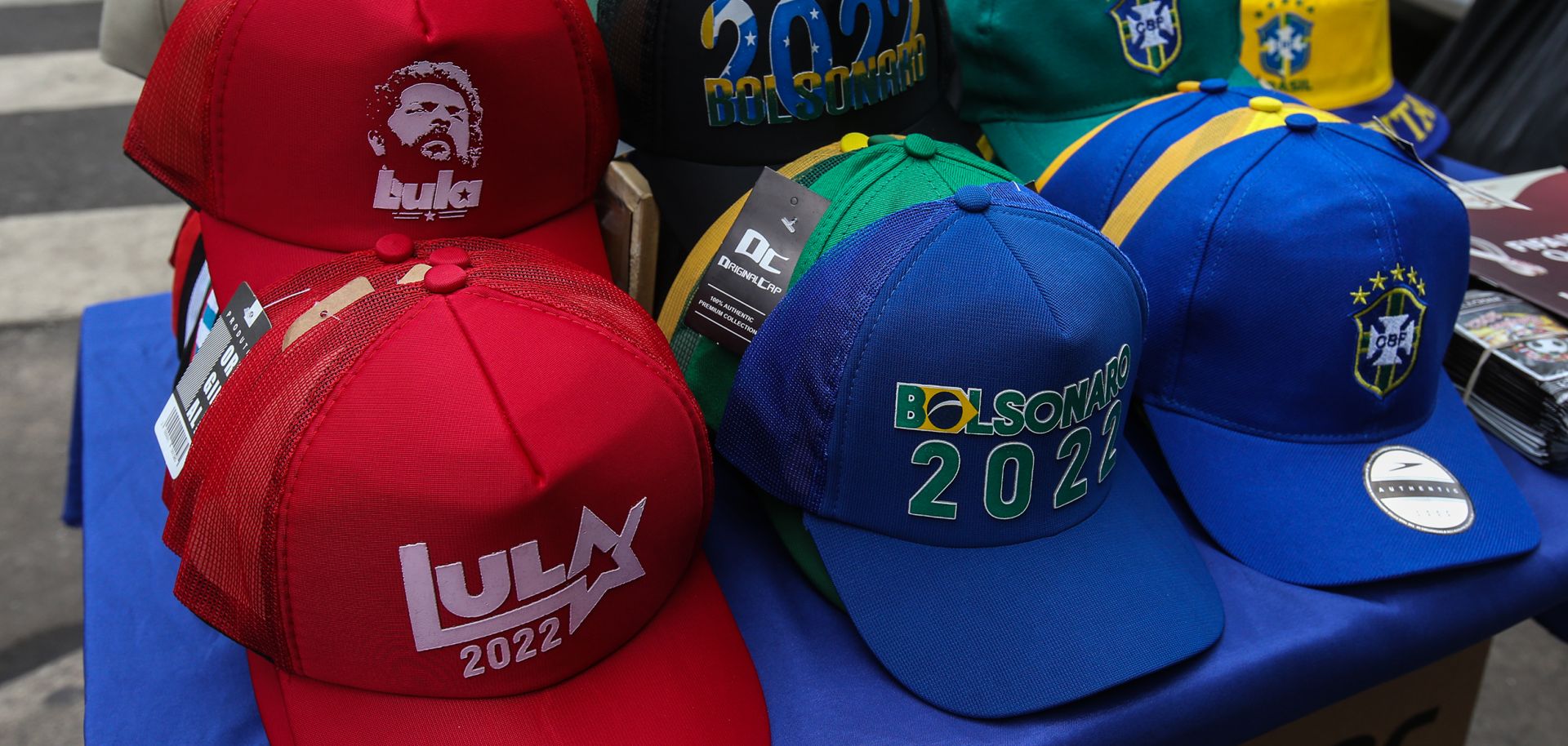 Caps are displayed to be sold at a street stand with names of presidential candidates Lula da Silva and Jair Bolsonaro in downtown Sao Paulo