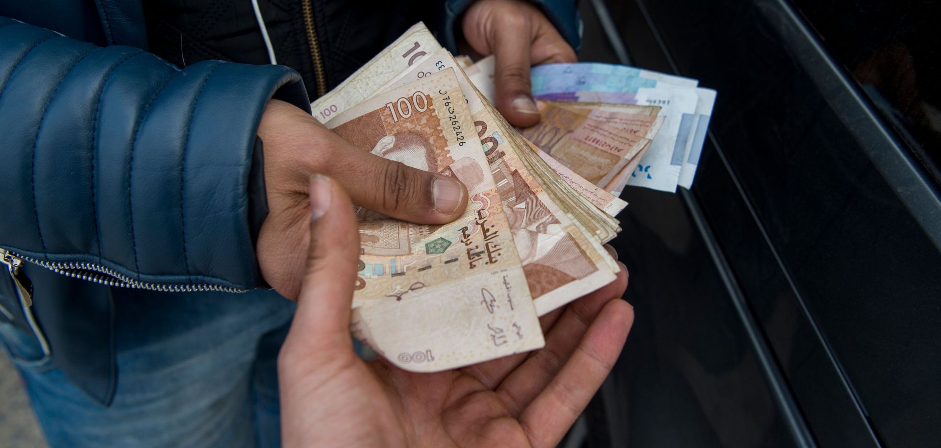 Man holding Moroccan currency 