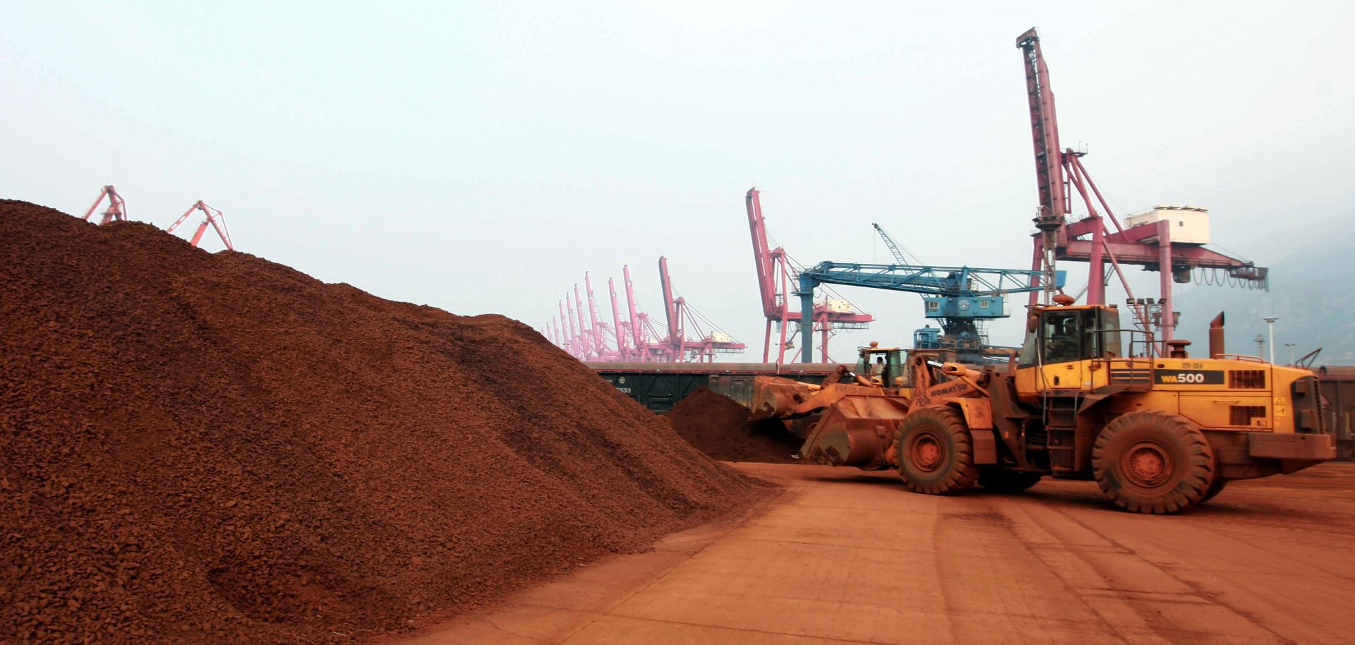 A worker moves soil containing rare earth minerals at a port in China. 