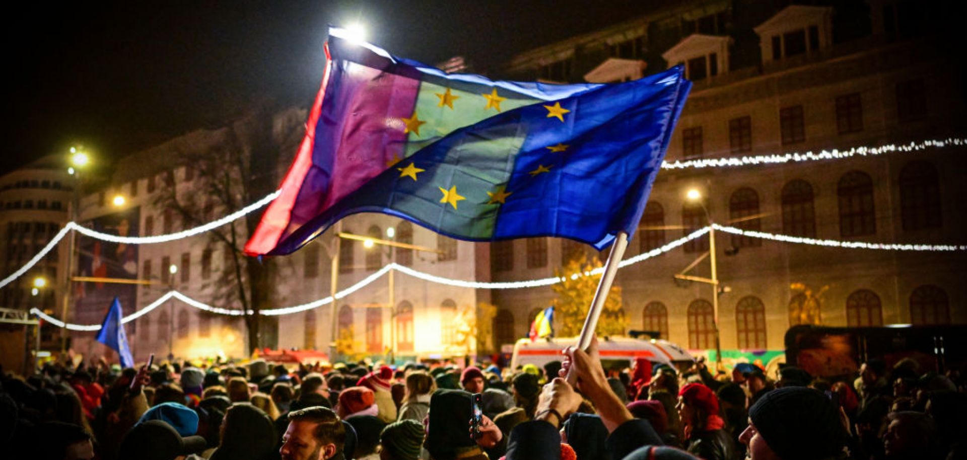 Demonstrators hold EU and Romanian national flags during a pro-European rally in support of democracy at University Square in Bucharest, Romania, on Dec. 5, 2024, a few days before key elections. 