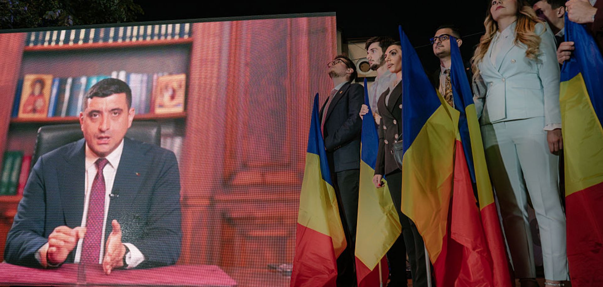 Presidential candidate George Simion is shown on a screen addressing his supporters at the campaign headquarters of their candidate after polls closed on May 4, 2025 in Bucharest, Romania.