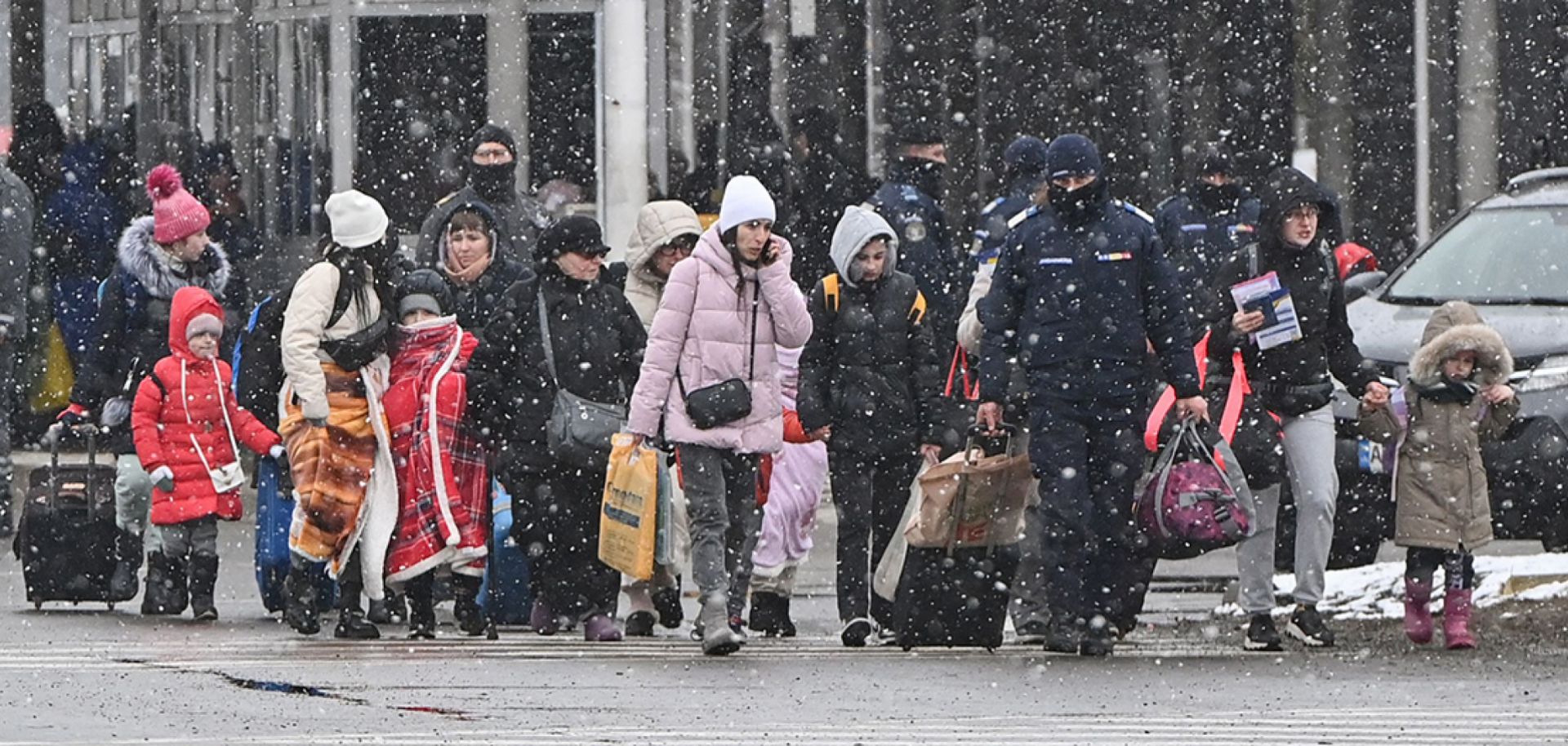 Refugees from Ukraine walk at the Ukrainian-Romanian border in Siret on March 2, 2022.