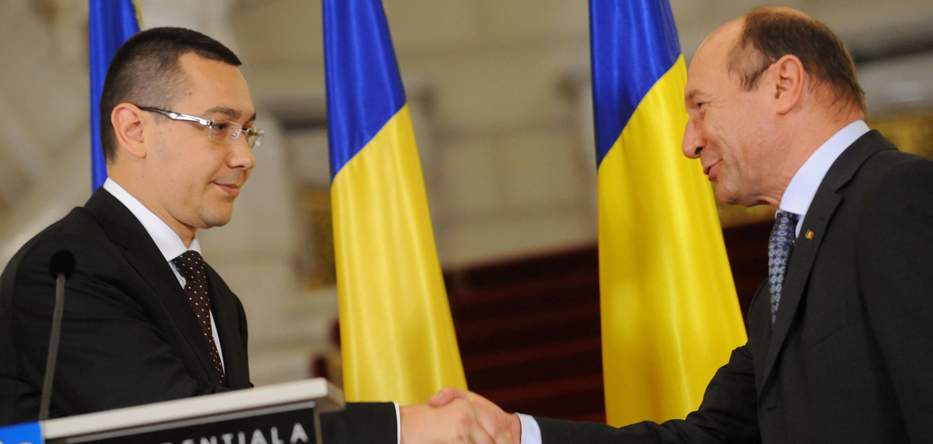 Romanian President Traian Basescu (R) shakes hands with designated Prime Minister Victor Ponta (L) during the official nomination at the Cotroceni Palace, the Romanian Presidency headquarters April 27, 2012.