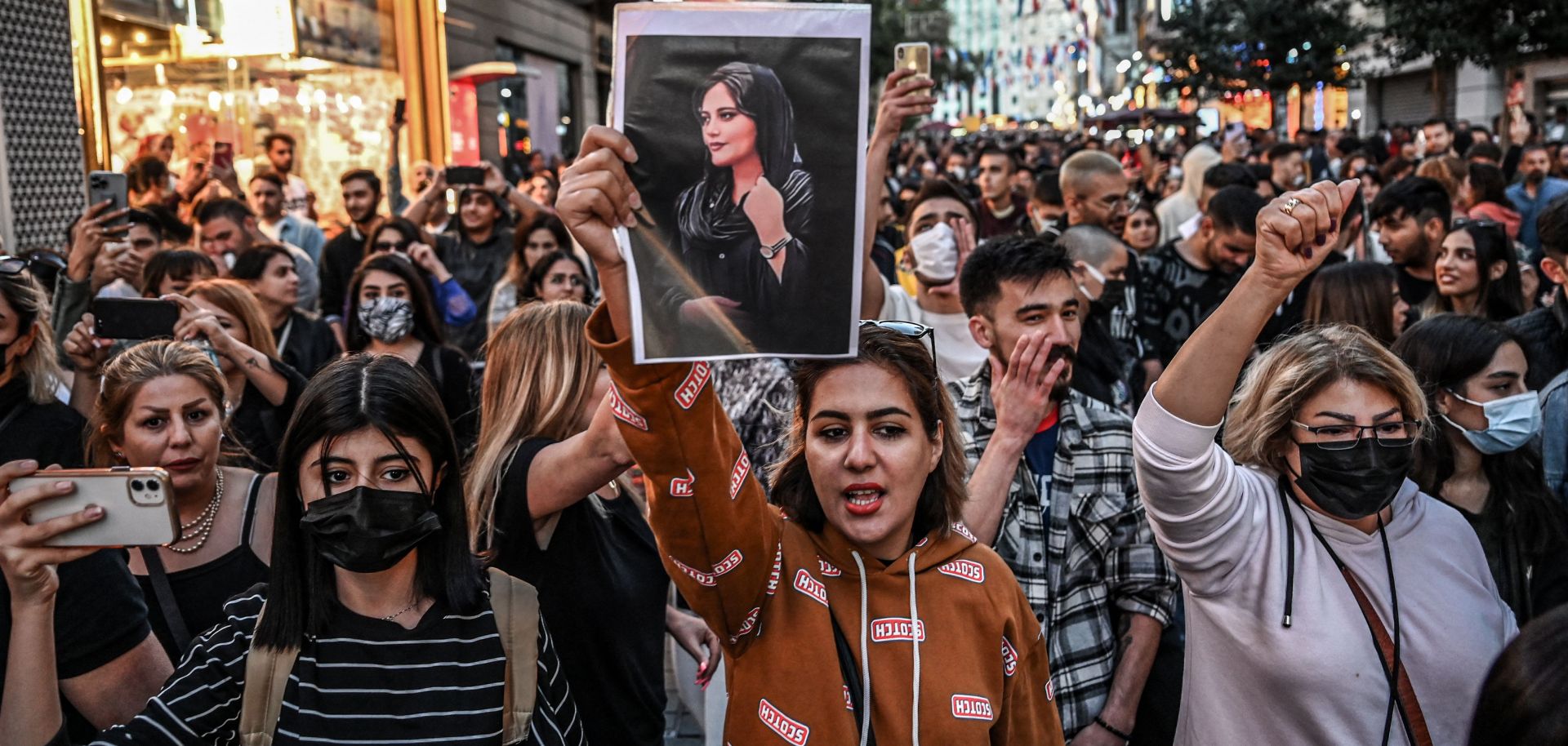 A protester in Turkey holds a portrait of Mahsa Amini during a demonstration in support of Amini, a young Iranian woman who died Sept. 16 after being arrested in the Iranian capital of Tehran by the morality police. 