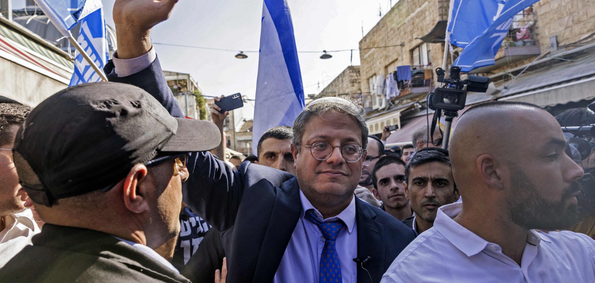 Israeli far-right lawmaker and Otzma Yehudit leader Itamar Ben-Gvir (C) greets supporters during a campaign rally Oct. 28, 2022, in Jerusalem's Mahane Yehuda Market.