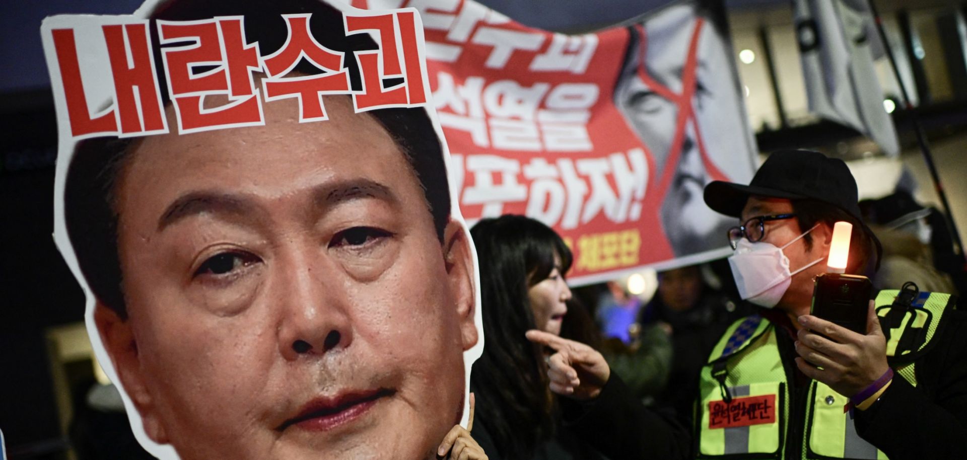 A sign reading ''leader of insurgents'' on a photo of South Korean President Yoon Suk Yeol's face is held up during a protest calling for Yoon's ouster in Seoul, South Korea, on Dec. 8, 2024. 