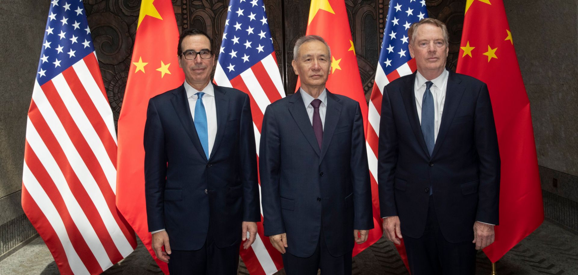 U.S. Treasury Secretary Steven Mnuchin (left) and U.S. Trade Representative Robert Lighthizer flank Chinese Vice Premier Liu He as they pose for photographs before holding trade talks in Shanghai on July 31, 2019.