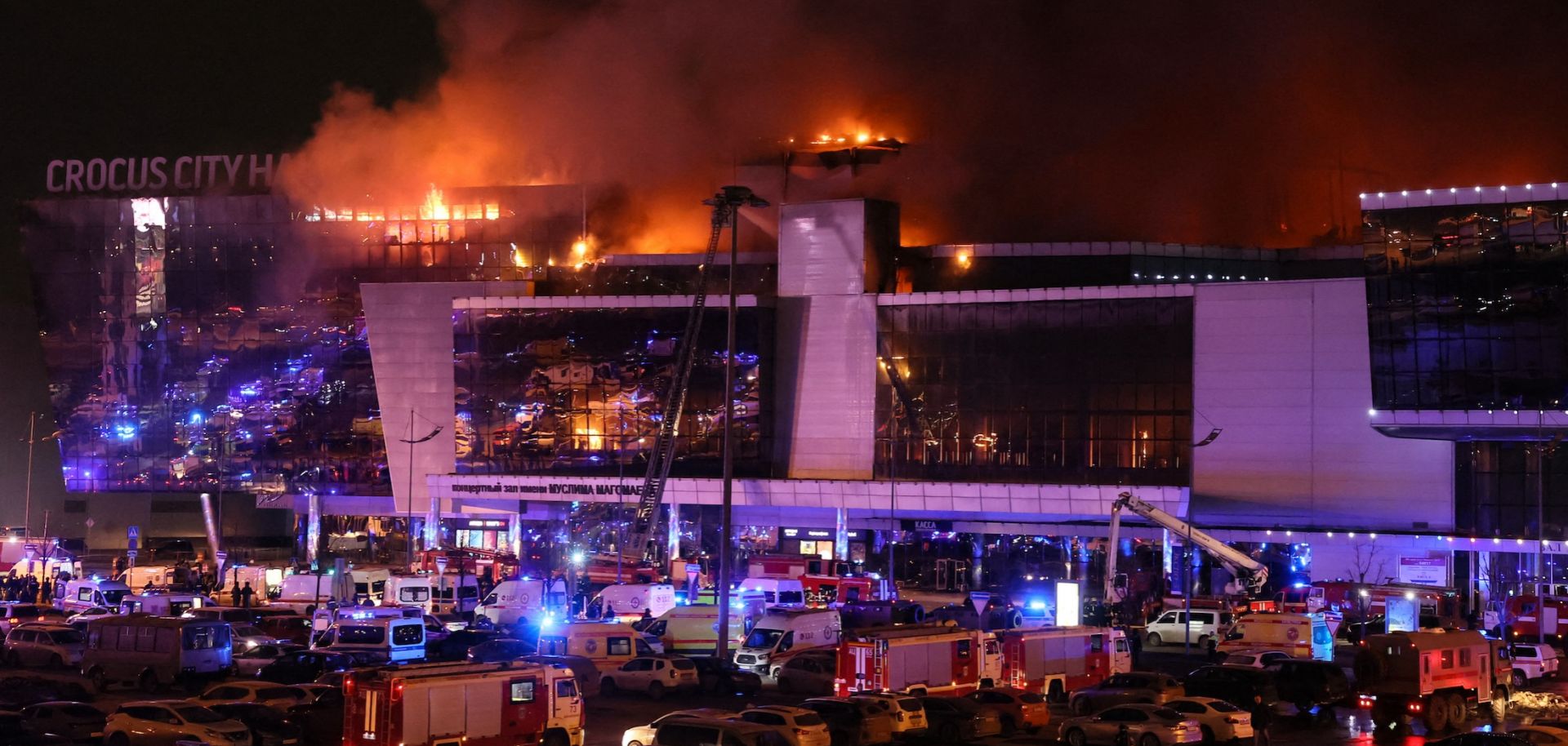 Emergency services vehicles are seen outside the burning Crocus City Hall concert hall following a shooting incident in Krasnogorsk, outside Moscow, Russia, on March 22, 2024. 