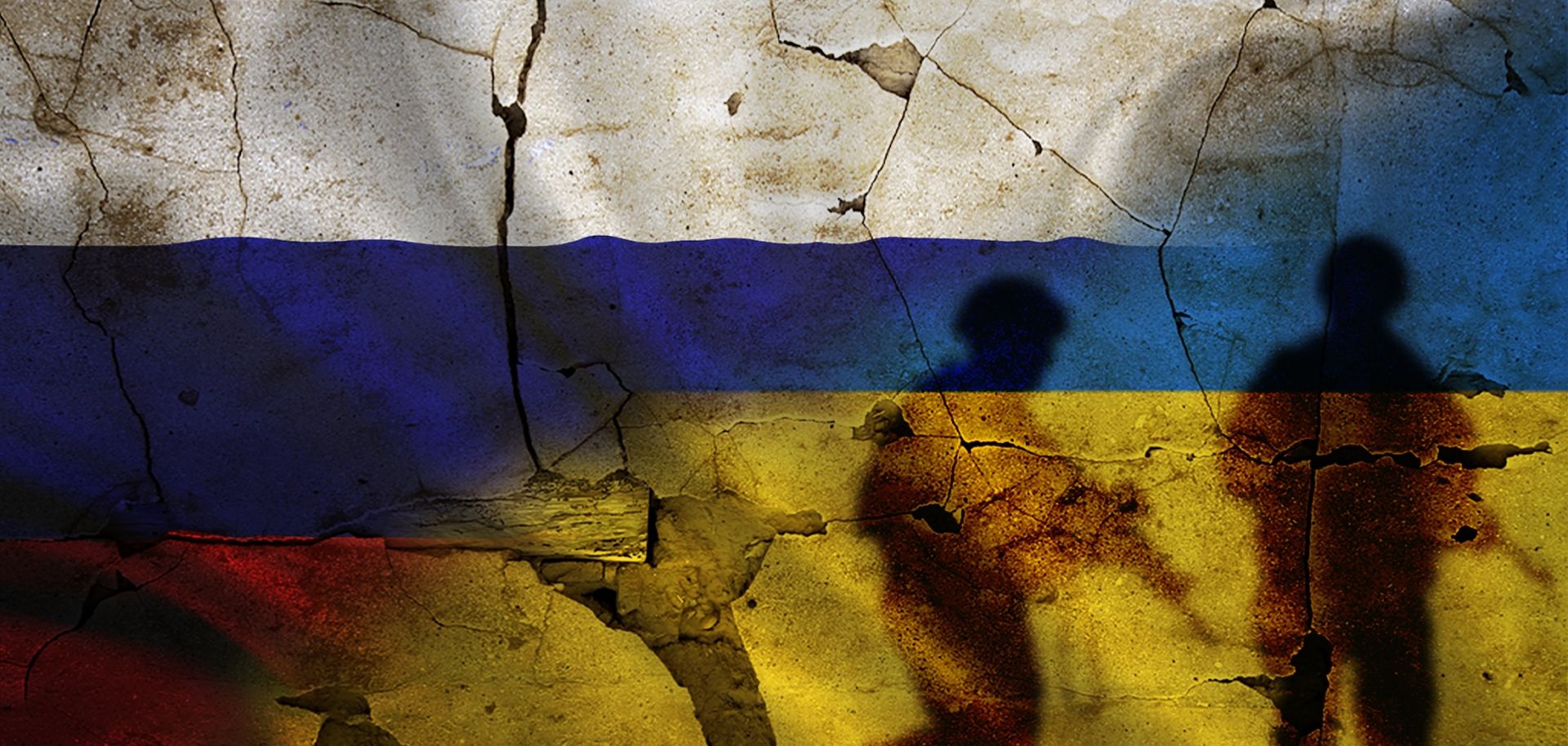 Russia and Ukraine flags on a cracked wall with the silhouettes of soldiers.