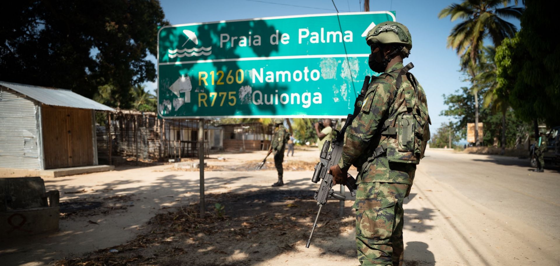 A Rwandan soldier walks in front of a burned truck near Palma in Mozambique’s Cabo Delgado region on Sept. 22, 2021. 