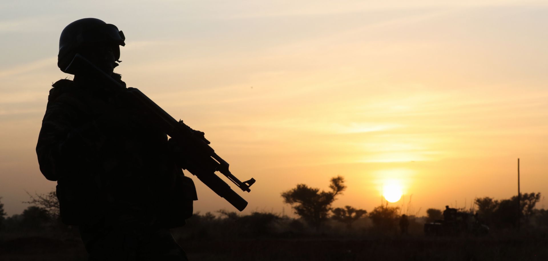 This photo shows the outline of a soldier standing guard at sunset in Niamey, Niger, on Dec. 22, 2019.