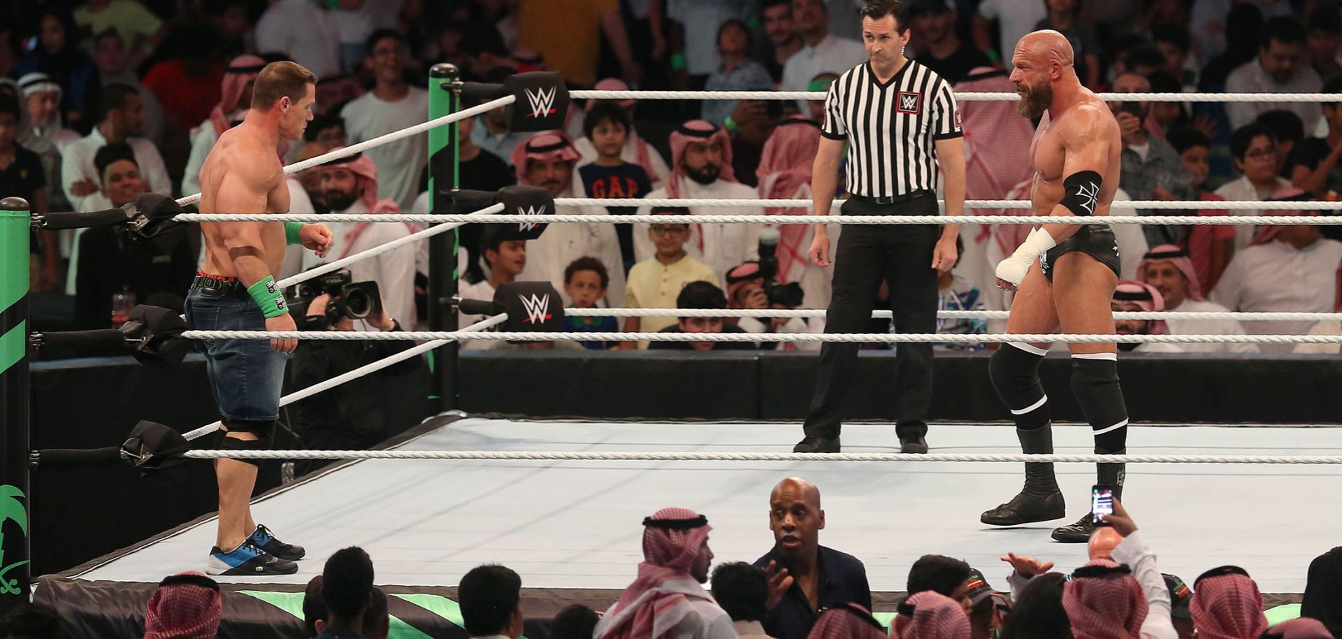 John Cena (L) competes with Triple H during the World Wrestling Entertainment (WWE) Greatest Royal Rumble event in Jeddah on April 27. 