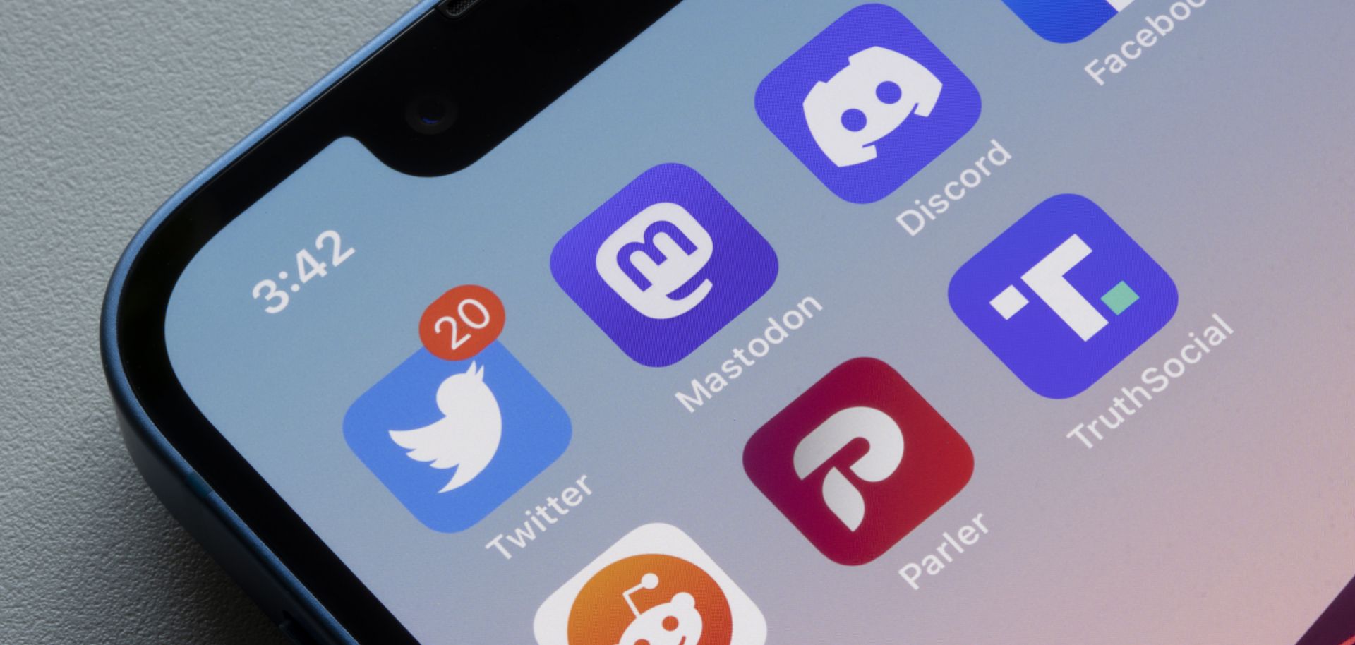 App icons of social media platforms Twitter, Mastodon, Discord, Facebook, Reddit, Parler and Truth Social, are seen on an iPhone. 