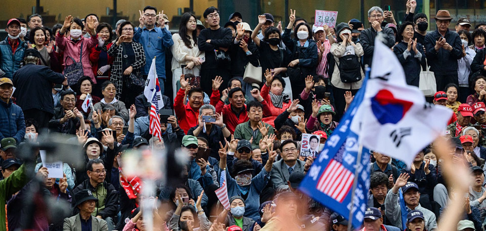 Supporters of Kim Moon Soo, the opposition candidate running in South Korea's June 3 presidential election, react during a campaign event in Seoul on May 19, 2025.