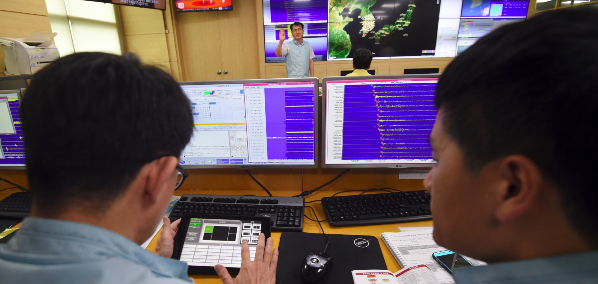 South Korean officials from the meteorological administration in Seoul monitor screens showing graphs of seismic waves originating from North Korea, Sept. 3.