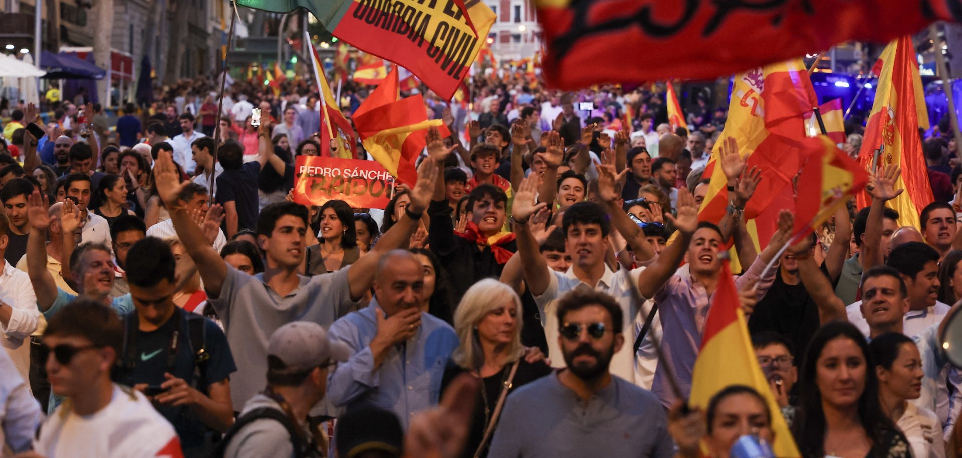 Supporters of the far-right Vox party wave flags and shout slogans during a protest against Spanish Prime Minister Pedro Sanchez in Madrid, on June 13, 2025.