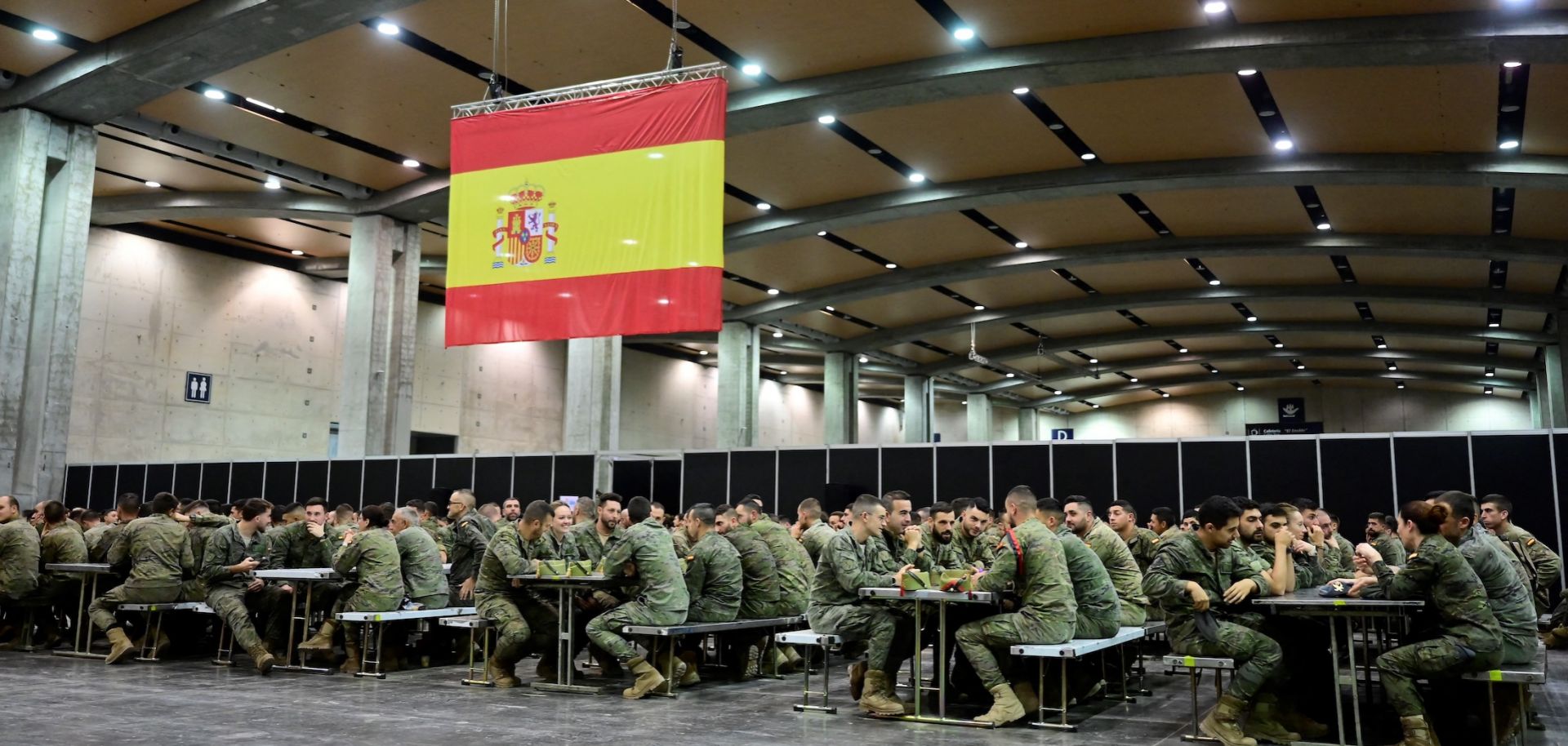 Spanish soldiers sit at tables at a makeshift military base in Valencia, eastern Spain, on Nov. 12, 2024, following deadly floods in the region.