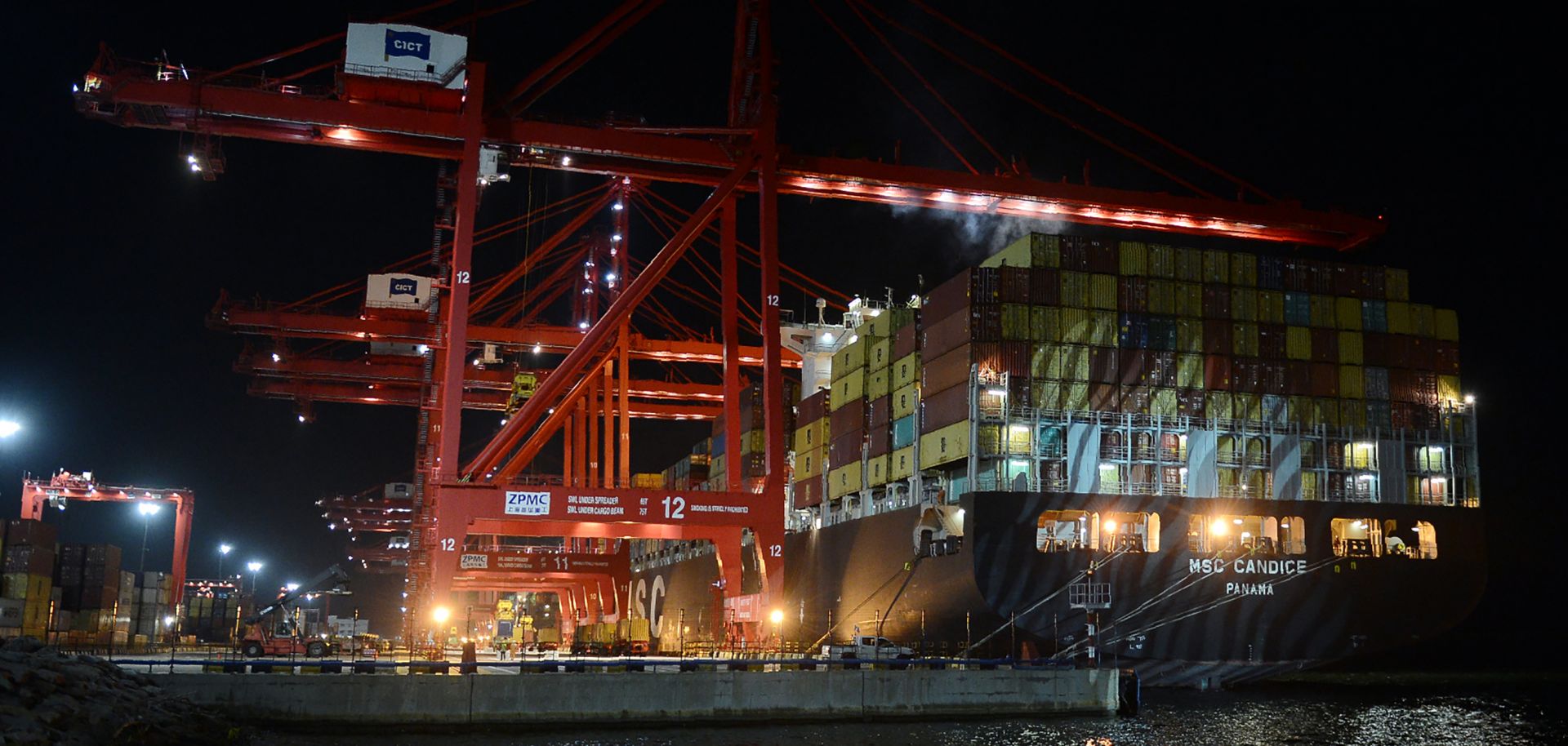 Workers at the Chinese-majority owned Colombo International Container Terminal (CICT) in Colombo load a cargo ship in this photograph from June 24, 2016.