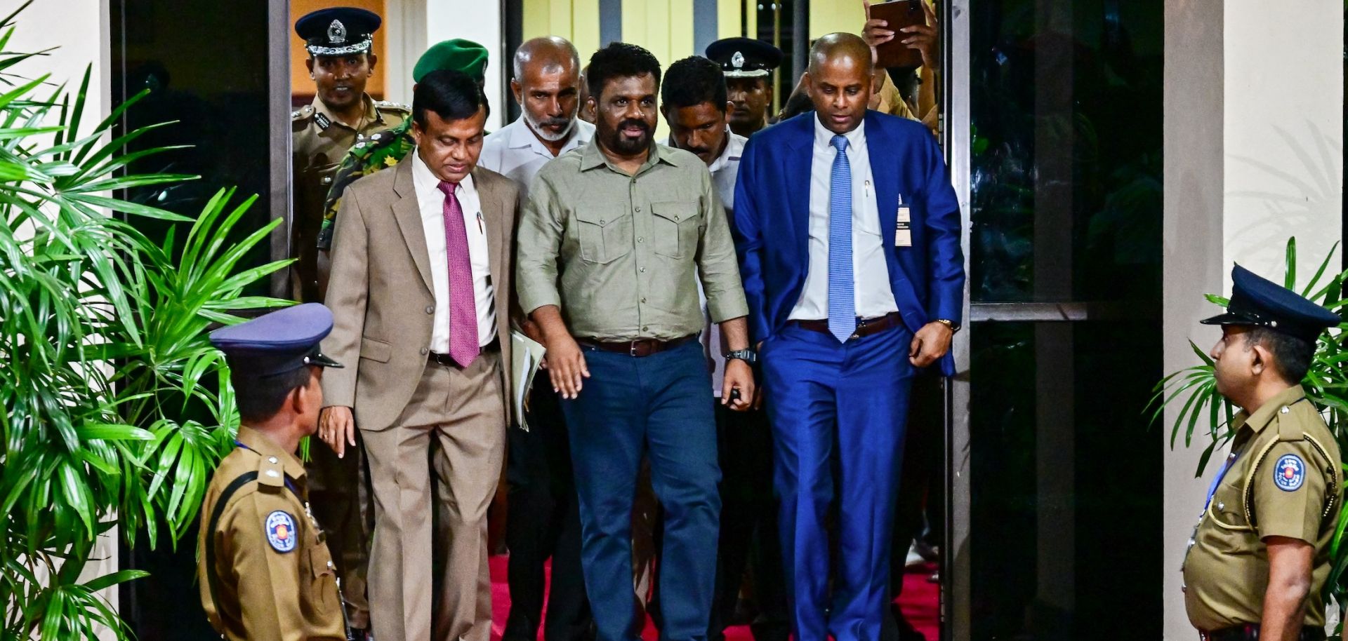 Anura Kumara Dissanayake (center) gestures as he leaves the office of Sri Lanka's Election Commission in Colombo on Sept. 22, 2024, following his victory in the country's presidential election. 