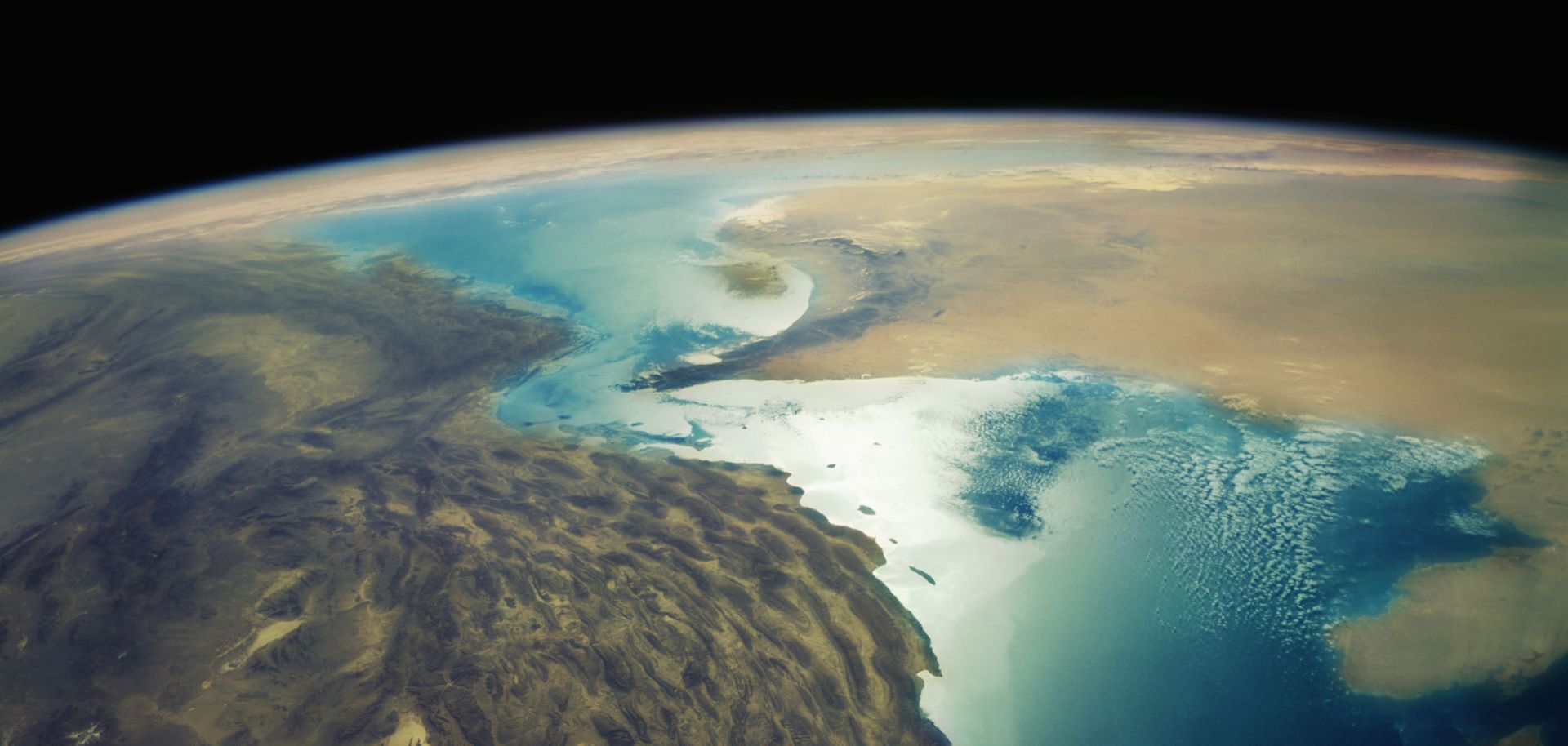 An aerial depiction of Iran's Zagros Mountains and the Strait of Hormuz.