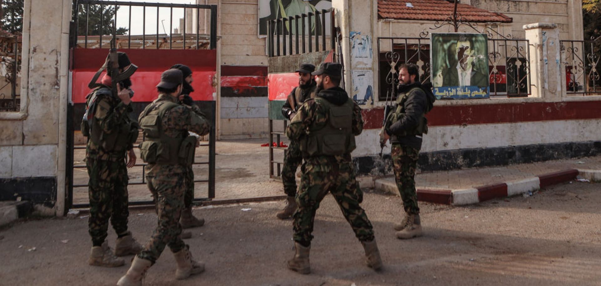 Fighters gather outside a building that was seized by jihadists in Syria's northern Aleppo province on Nov. 29, 2024, amid the Hayat Tahrir al-Sham (HTS) offensive against government forces.