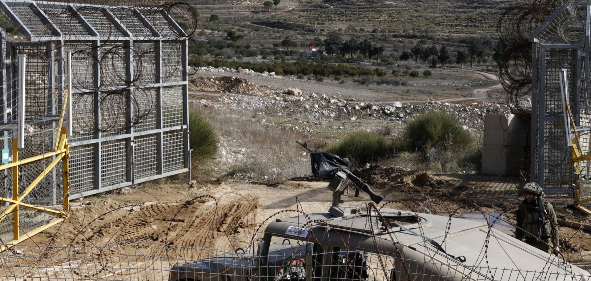 An Israeli army vehicle patrols near the fence leading into the U.N.-patrolled buffer zone, which separates Israeli and Syrian forces in the Golan Heights, on Jan. 5, 2025. 