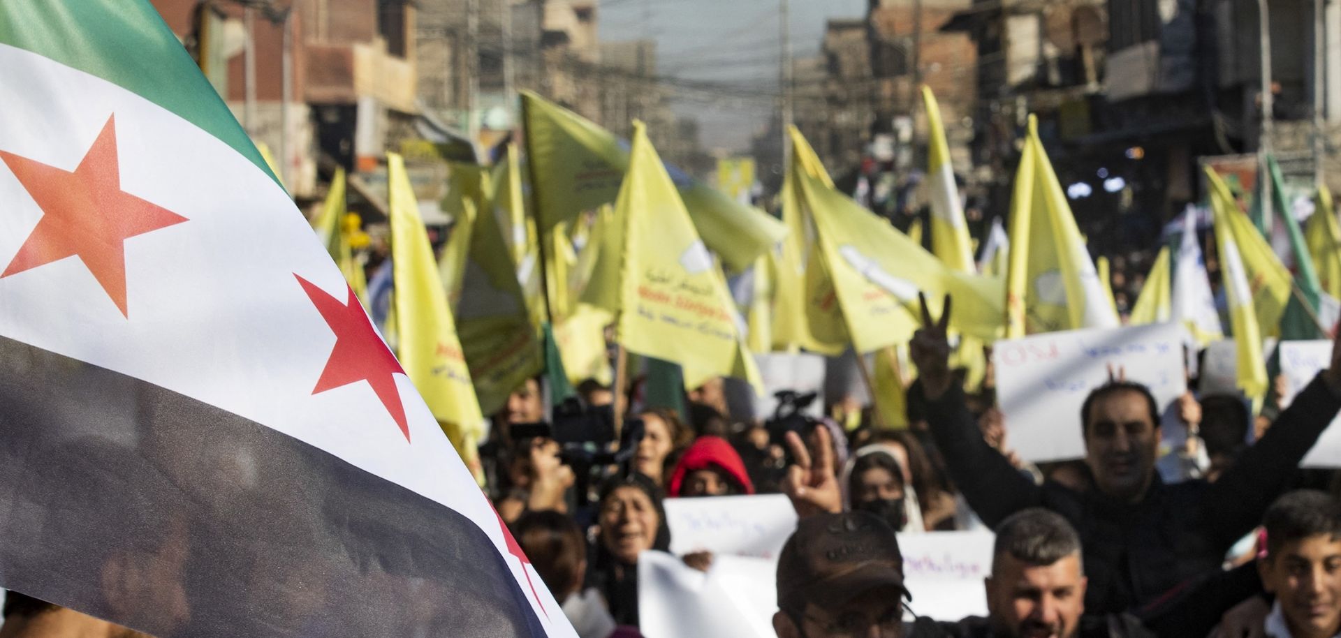 Syrian Kurds wave independence-era flags in support of the U.S.-backed, Kurdish-led Syrian Democratic Forces on Dec. 19, 2024, in the northeastern Syrian city of Qamishli.