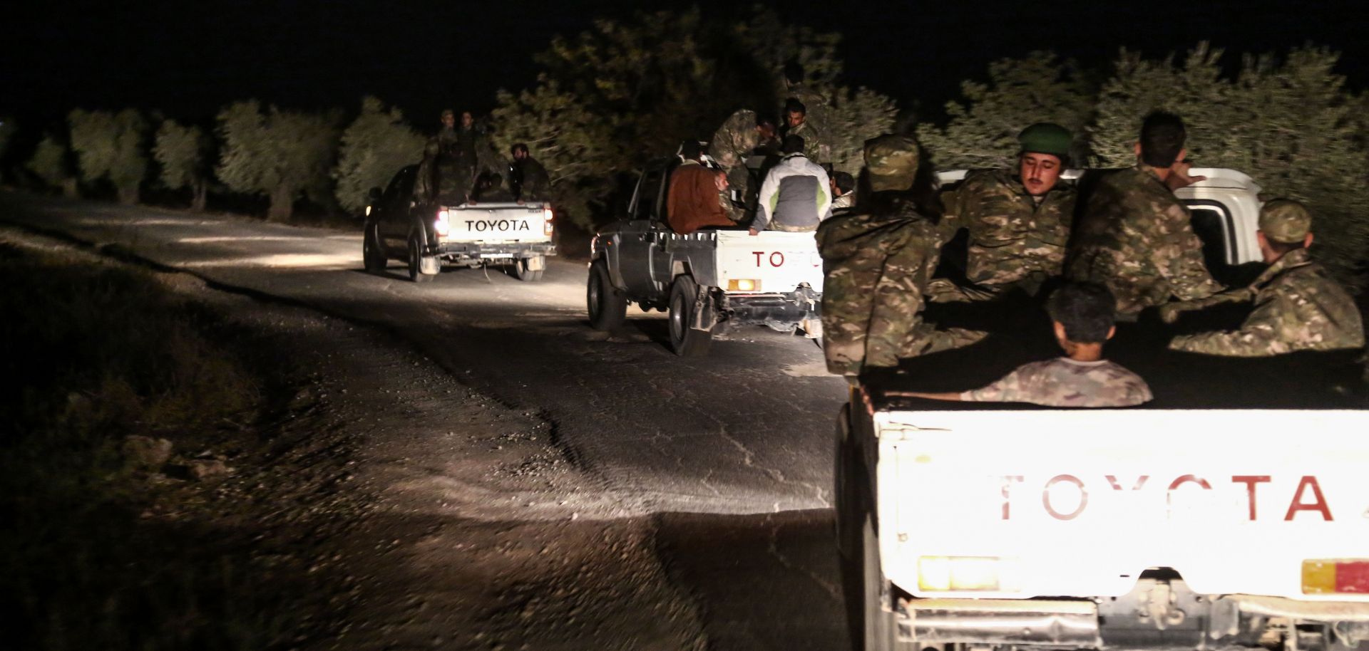 Turkish-backed Syrian rebel fighters advance toward jihadist-controlled Idlib province along the Syria-Turkey border on Oct. 6.