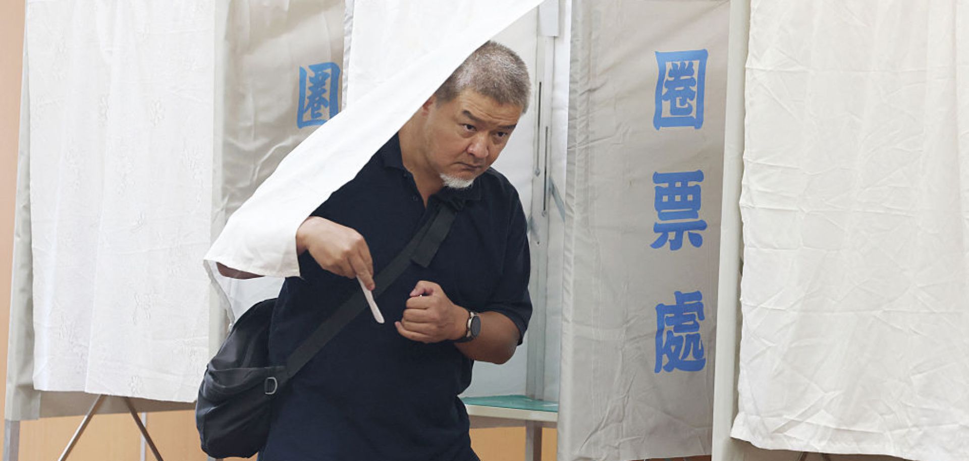 A voter leaves a booth during voting for the recall election at a polling station in Taipei, Taiwan, on July 26, 2025. 