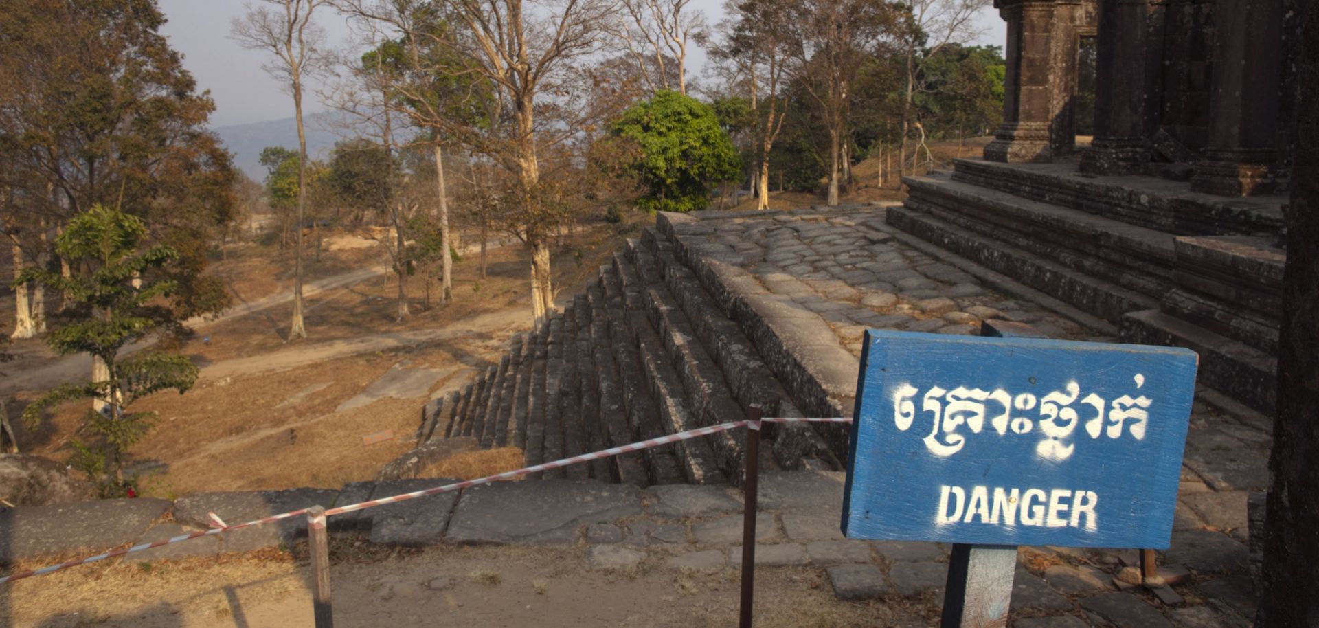 A ''Danger'' sign warns visitors about a fragile structure within the grounds of the Preah Vihear temple in Cambodia.