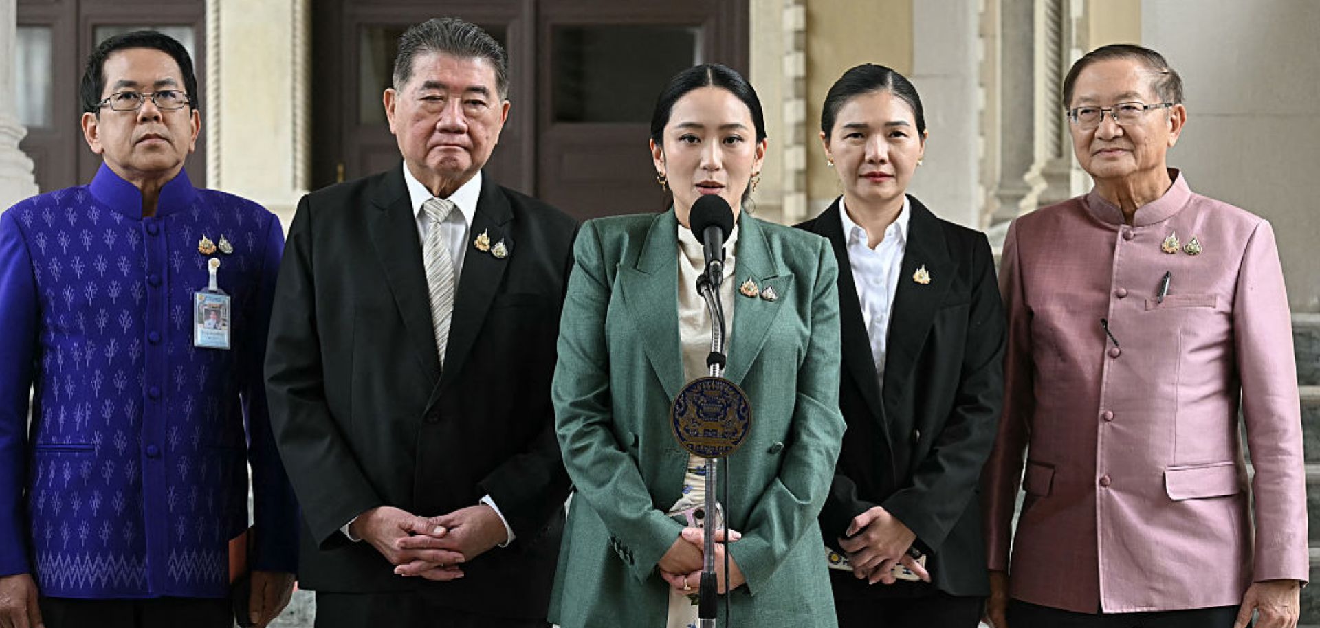 Thai Prime Minister Paetongtarn Shinawatra (center) speaks next to Deputy Prime Minister Phumtham Wechayachai (2nd from left) during a press conference in Bangkok following her suspension by the country's Constitutional Court on July 1, 2025. 