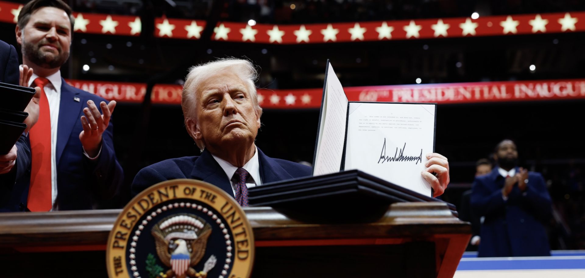 U.S. President Donald Trump holds up an executive order after signing it during an indoor inauguration parade at the Capital One Arena in Washington, D.C, on Jan. 20, 2025.