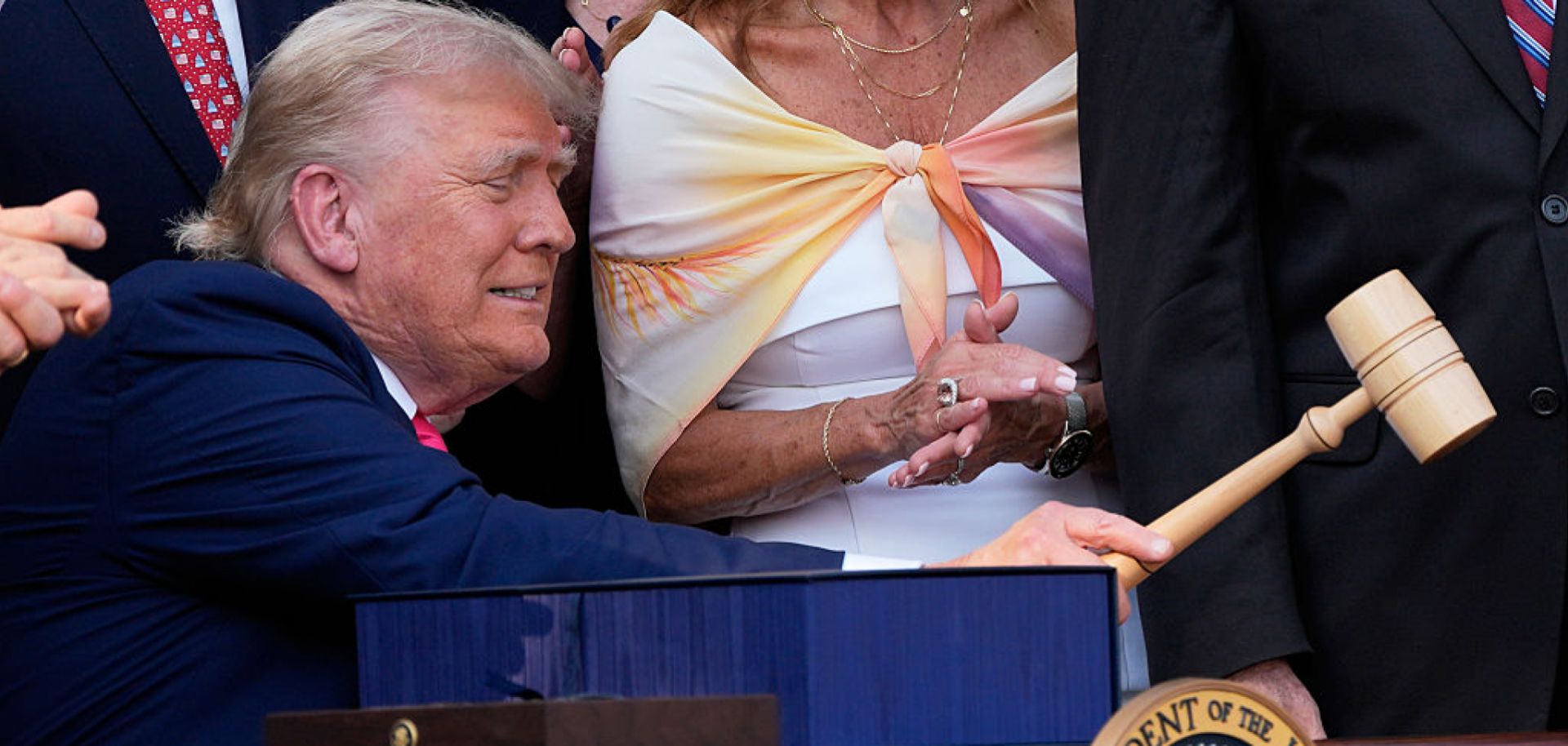 President Donald Trump bangs a gavel after signing a bill into law extending his 2017 tax cuts on July 4 in Washington.