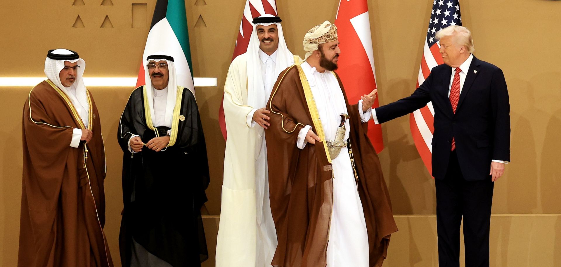 U.S. President Donald Trump (right) interacts with Oman Deputy Prime Minister Sayyid Asaad (second from right) as they prepare to pose for photos with leaders during the Gulf Cooperation Council (GCC) Leaders' Summit in Riyadh, Saudi Arabia, on May 14, 2025.