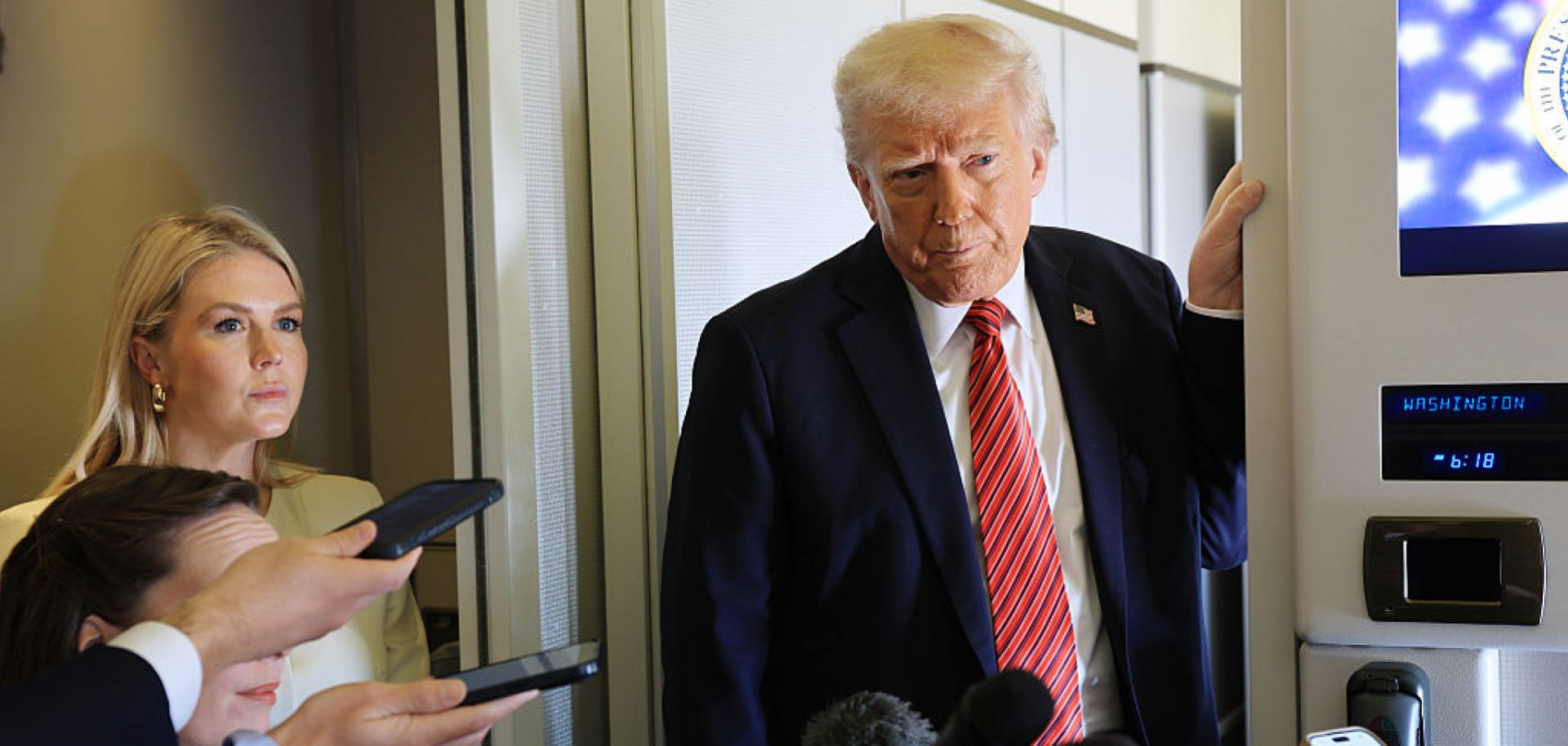 U.S. President Donald Trump talks to reporters aboard Air Force One on May 14, 2025, as he flies to Doha, Qatar, for his first trip to the Middle East since returning to the White House. 