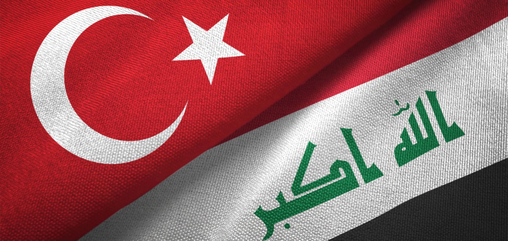 Iraq and Turkey's flags together on a textile cloth fabric 