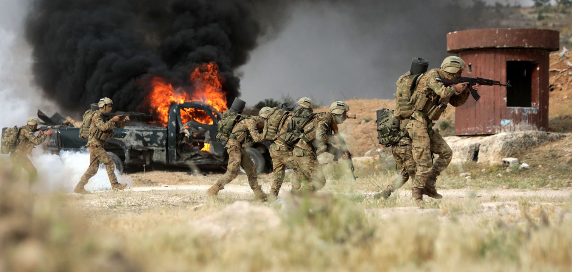 Turkey-backed Syrian fighters conduct military exercises in Syria's northern city of Manbij on June 2.