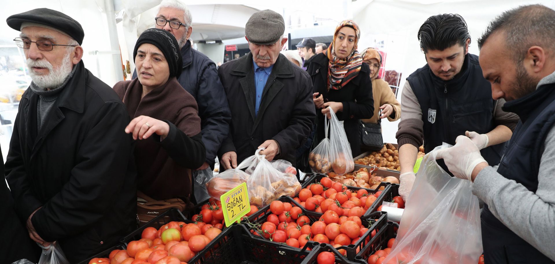 People line up to buy subsidized vegetables at a tent set up by the Ankara Metropolitan Municipality in the Cankaya district of the Turkish capital on Feb. 13, 2019.