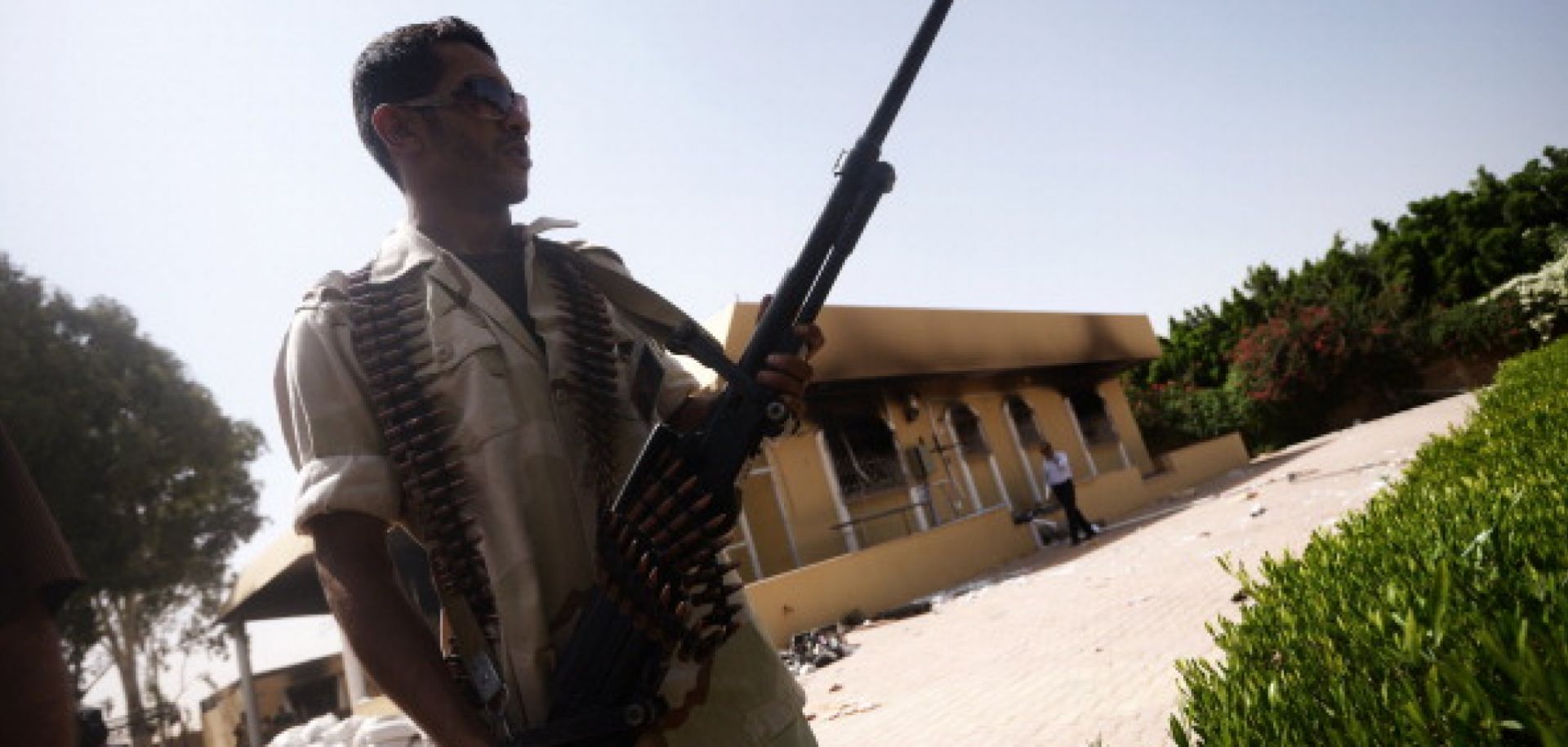A member of the Libyan security forces patrols the area outside the U.S. consulate in Benghazi two days after suspected Islamic militants fired on the compound on December 12, 2012, killing U.S. ambassador Chris Stevens. 