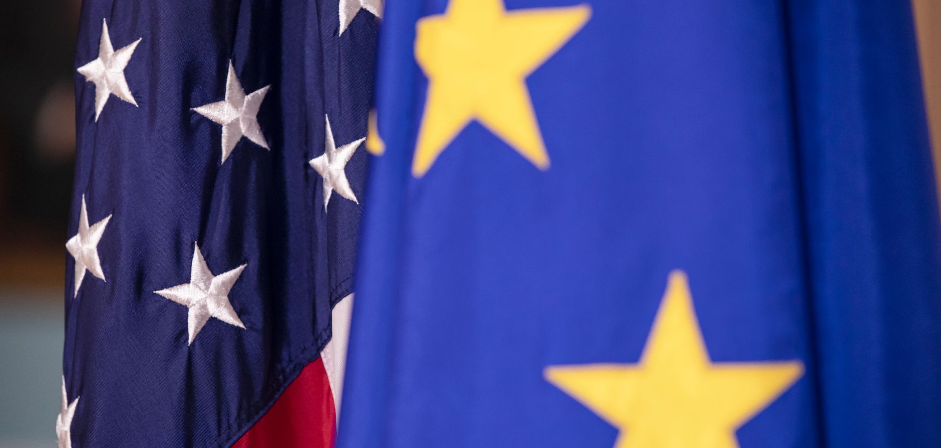 The U.S. and EU flags are seen next to each other.