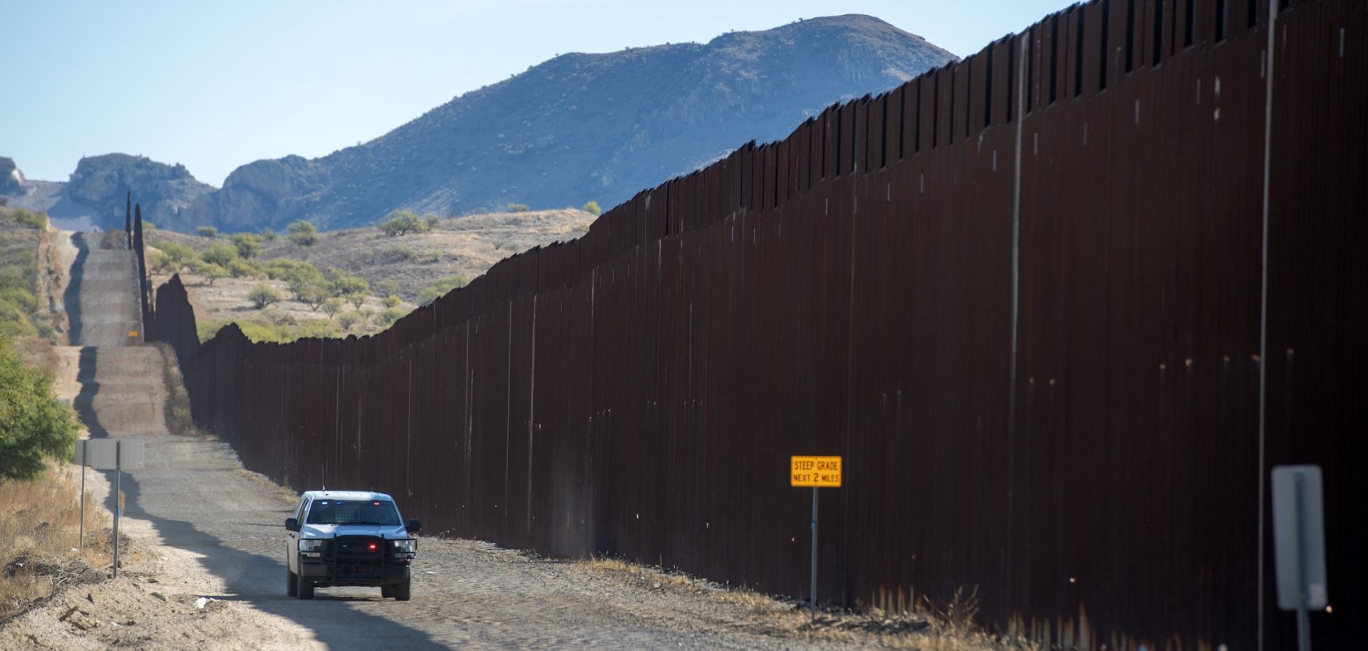 U.S. border patrol officials drive near the wall along the Mexican border in Sasabe, Arizona, on Dec. 8, 2023. 