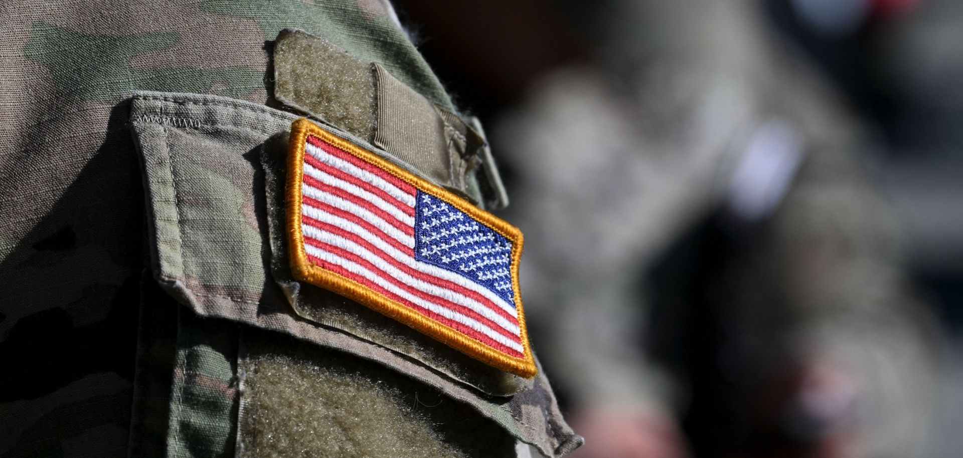 A U.S. flag is pictured on a soldier's uniform at the United States Army military training base in Grafenwoehr, southern Germany, on March 11, 2022.