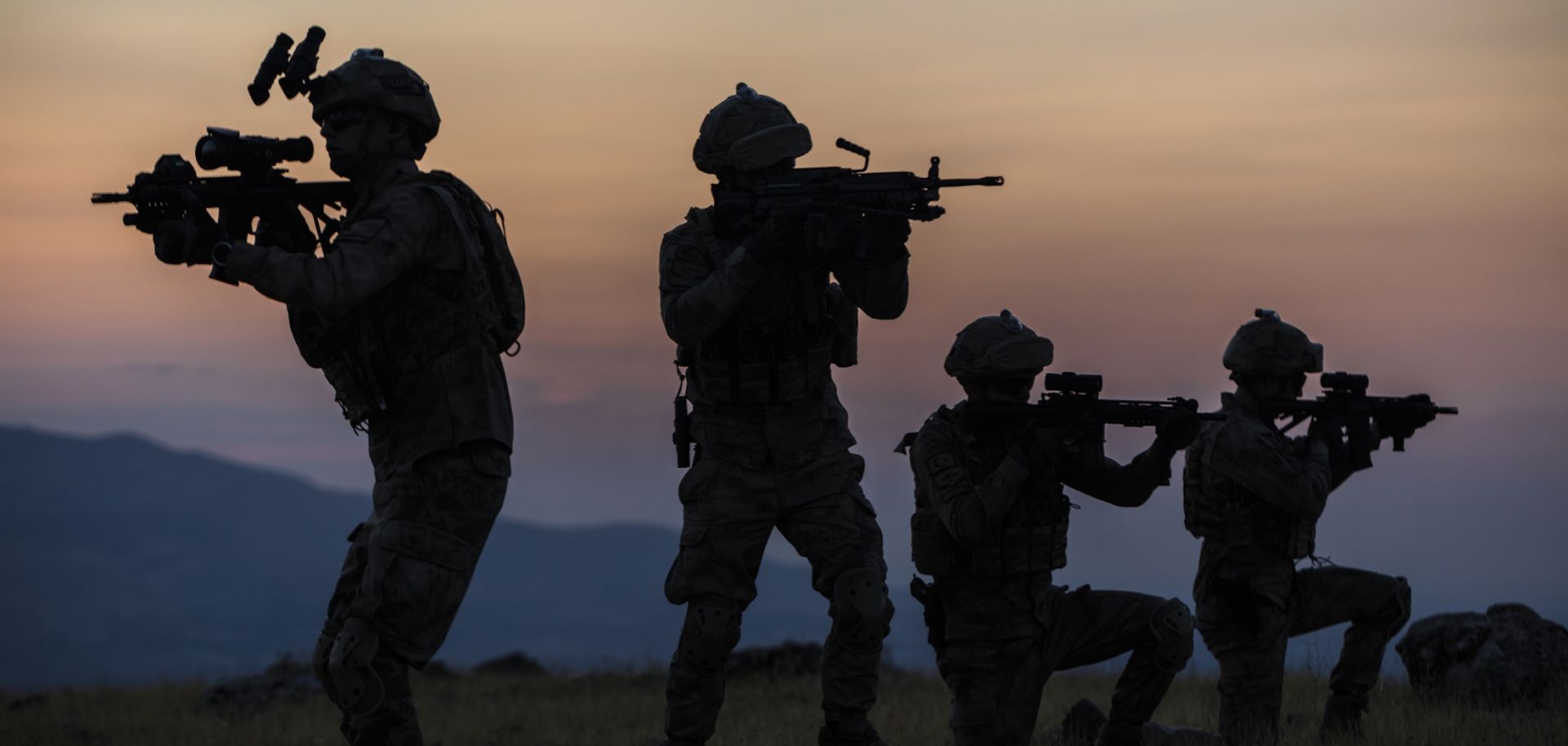 A stock image shows the silhouettes of soldiers.