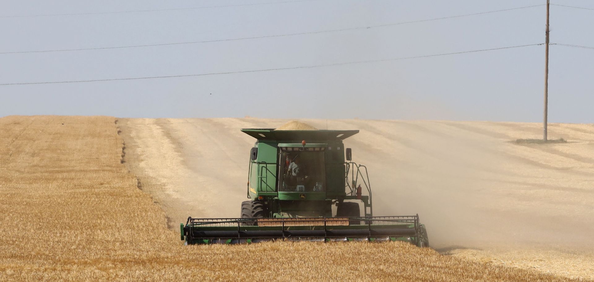 A farmer harvests wheat June 14, 2022, on a field near Izmail, in the Odesa region of Ukraine.