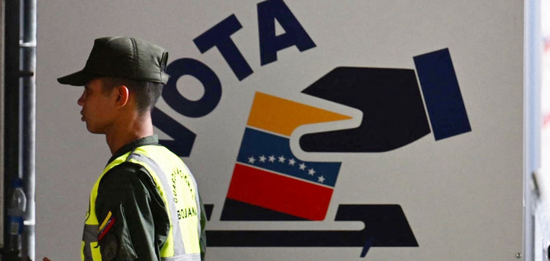 A member of Venezuela’s national guard walks past the information center of the country’s National Electoral Council (CNE) in Caracas on July 16, 2024, ahead of the upcoming presidential election.