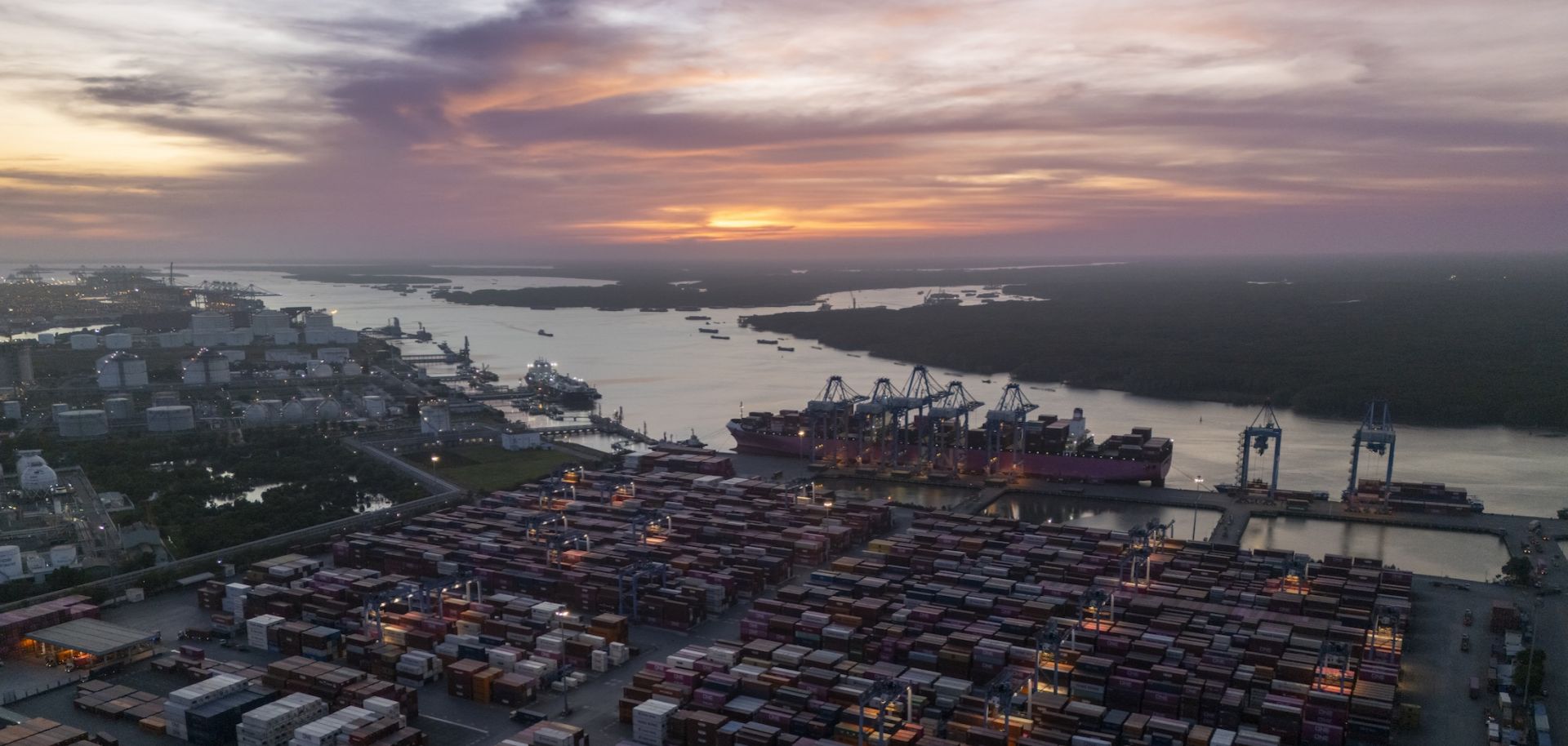 A large container ship is seen docked at a port. 