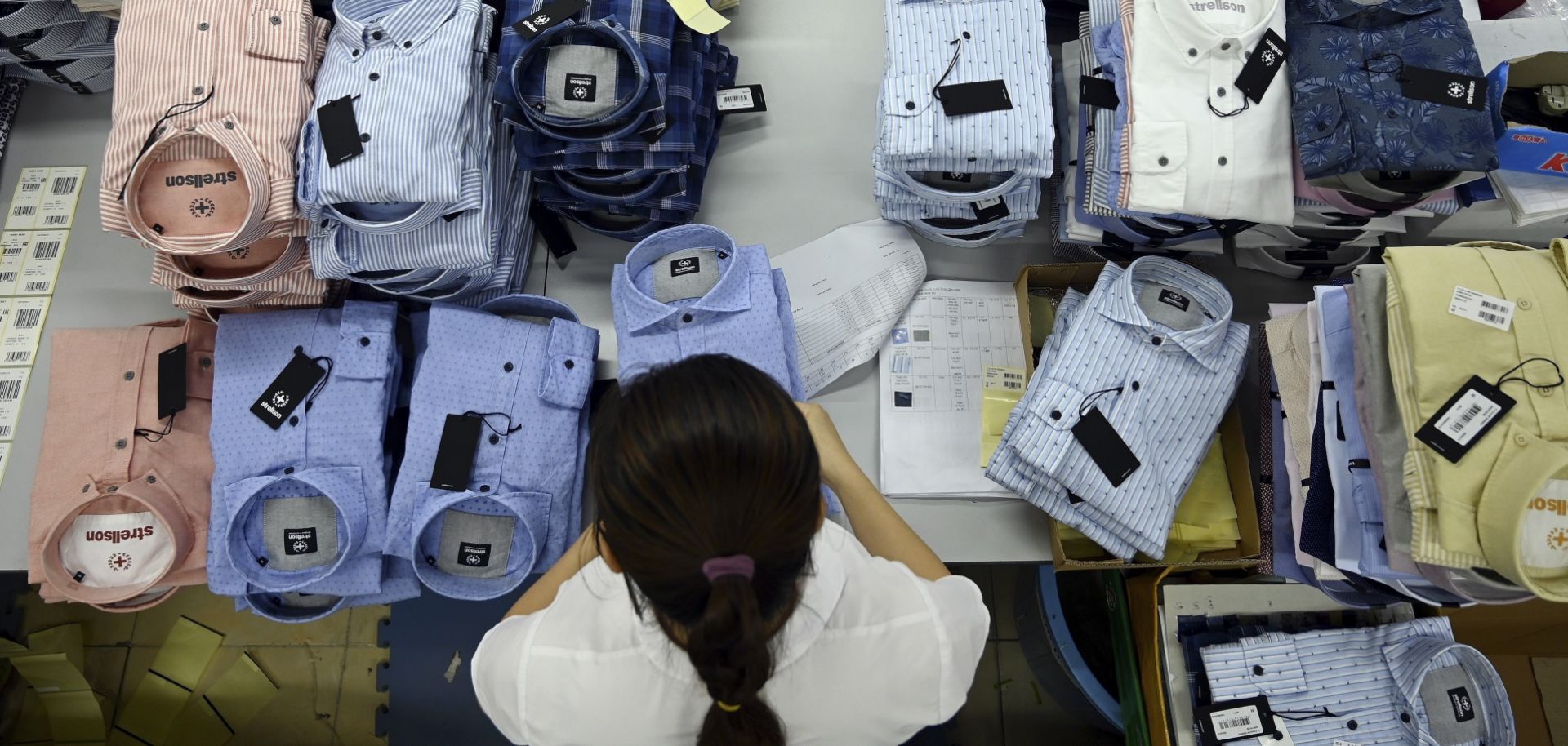 A garment worker prepares shirts for shipment in a factory in Hanoi, Vietnam, on May 24, 2019.