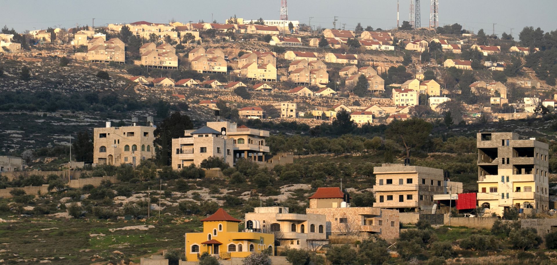 This picture taken on Feb. 22, 2020, shows the Palestinian West Bank village of Azmut, east of Nablus, with the Israeli settlement of Elon Moreh in the background.
